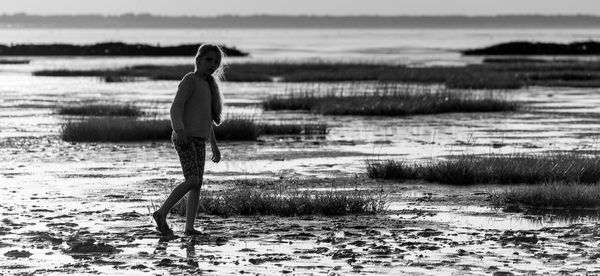 Woman standing on field at beach