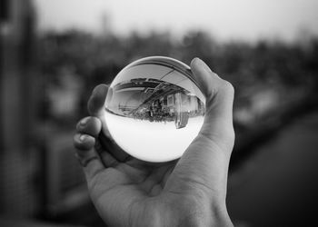 Close-up of hand holding crystal ball