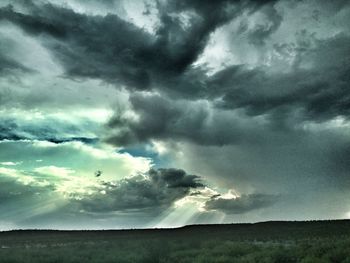 Scenic view of landscape against cloudy sky