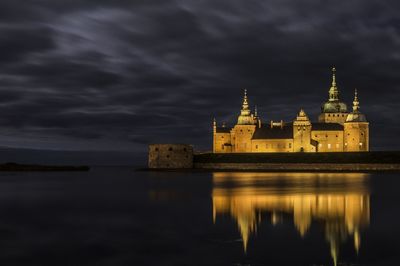 Reflection of building in water at night