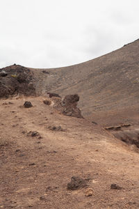 Scenic view of arid landscape against sky