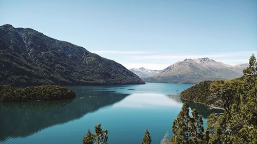 Panoramic view of lake and mountains against clear blue sky