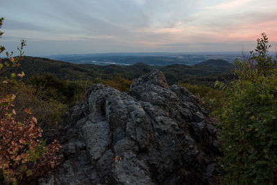 Rock formations on landscape against sky during sunset