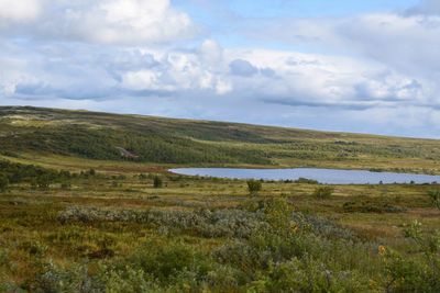 Scenic view of landscape against cloudy sky