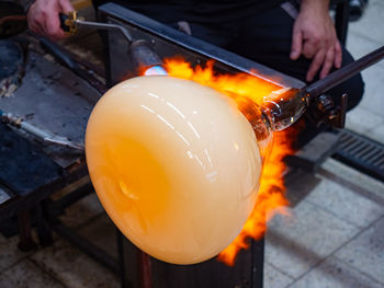 Glass artist forms the scorching glass with heats it with a gas burner torch.  czech artist's method