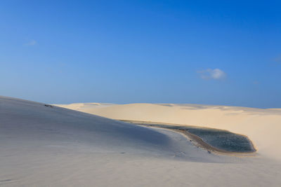 Scenic view of desert against blue sky