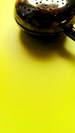 Close-up of yellow object over white background