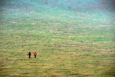 Men walking on field