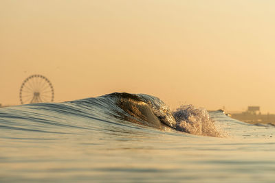 Scenic view of sea against clear sky during sunset