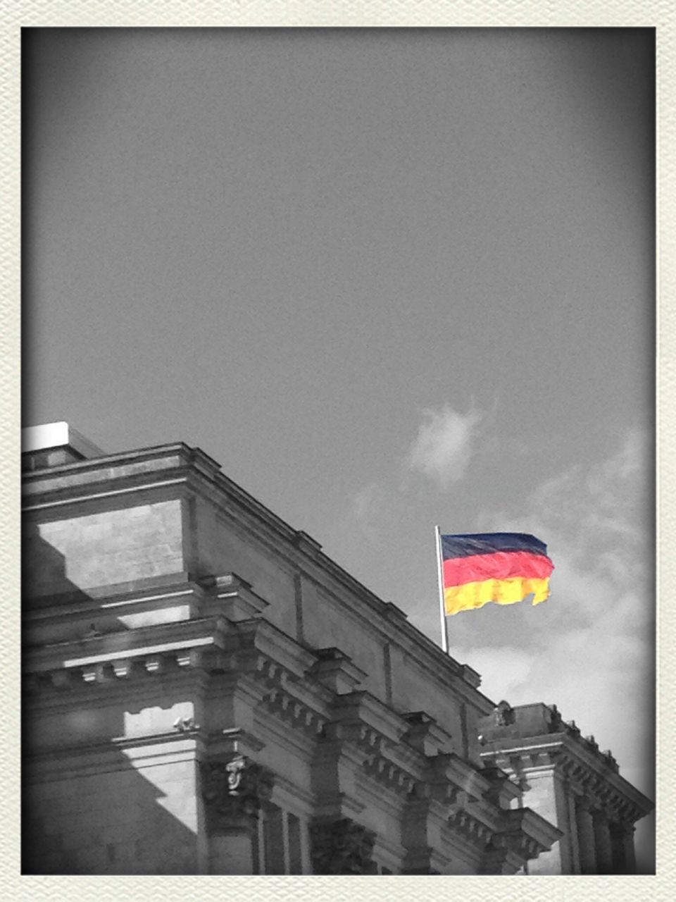 transfer print, low angle view, auto post production filter, flag, sky, built structure, architecture, building exterior, patriotism, identity, national flag, american flag, day, outdoors, no people, cloud, cloud - sky, clear sky, culture, copy space