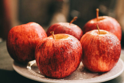 Close-up of apples in plate on table