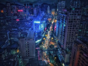 Aerial view of city lit up at night