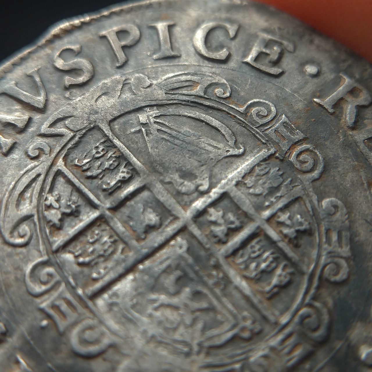 CLOSE-UP OF COINS ON METAL