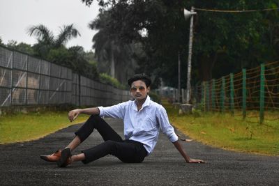 Young man sitting on field