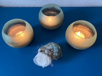 High angle view of lit candle on table