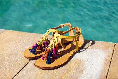 High angle view of shoes on swimming pool against sea