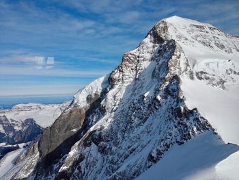 Scenic view of snow mountains against sky