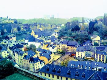 High angle view of houses in town against clear sky