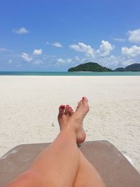 Low section of woman relaxing on beach