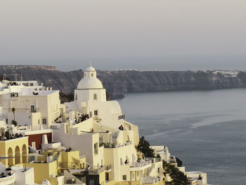 High angle view of townscape by sea against sky