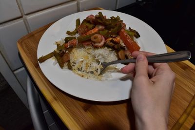 High angle view of person preparing food in plate