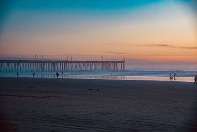 Scenic view of beach against sky during sunset