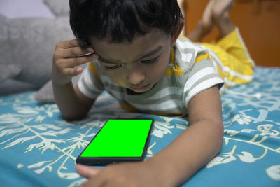 Close-up of boy using digital tablet at home