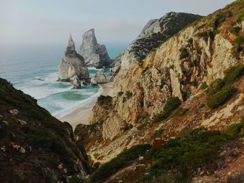 Scenic view of sea and mountains against sky