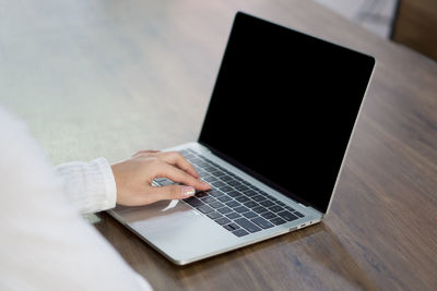 Low angle view of man using laptop on table