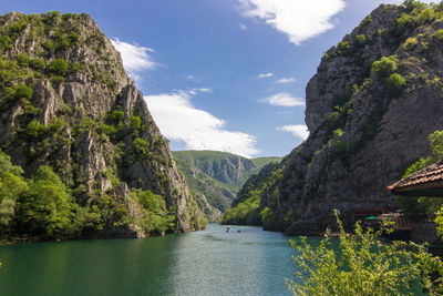 Scenic view of river and mountains against sky