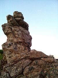 Low angle view of rock against clear sky