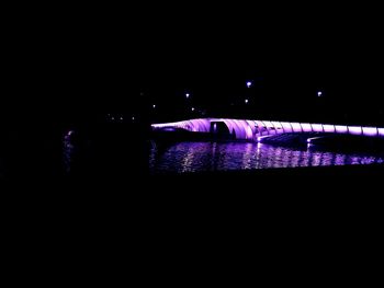 Illuminated lights on river at night