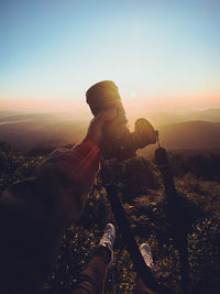 Man photographing at sunset