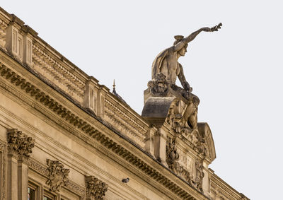 Low angle view of statue against building