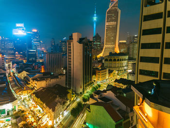 High angle view of illuminated buildings in city at night