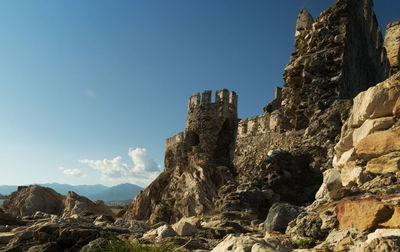 Low angle view of rock formation against sky