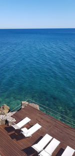 High angle view of swimming pool by sea against clear sky