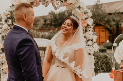 Portrait of bride and bridegroom standing in traditional clothing