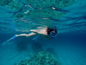 Full length of woman snorkeling undersea