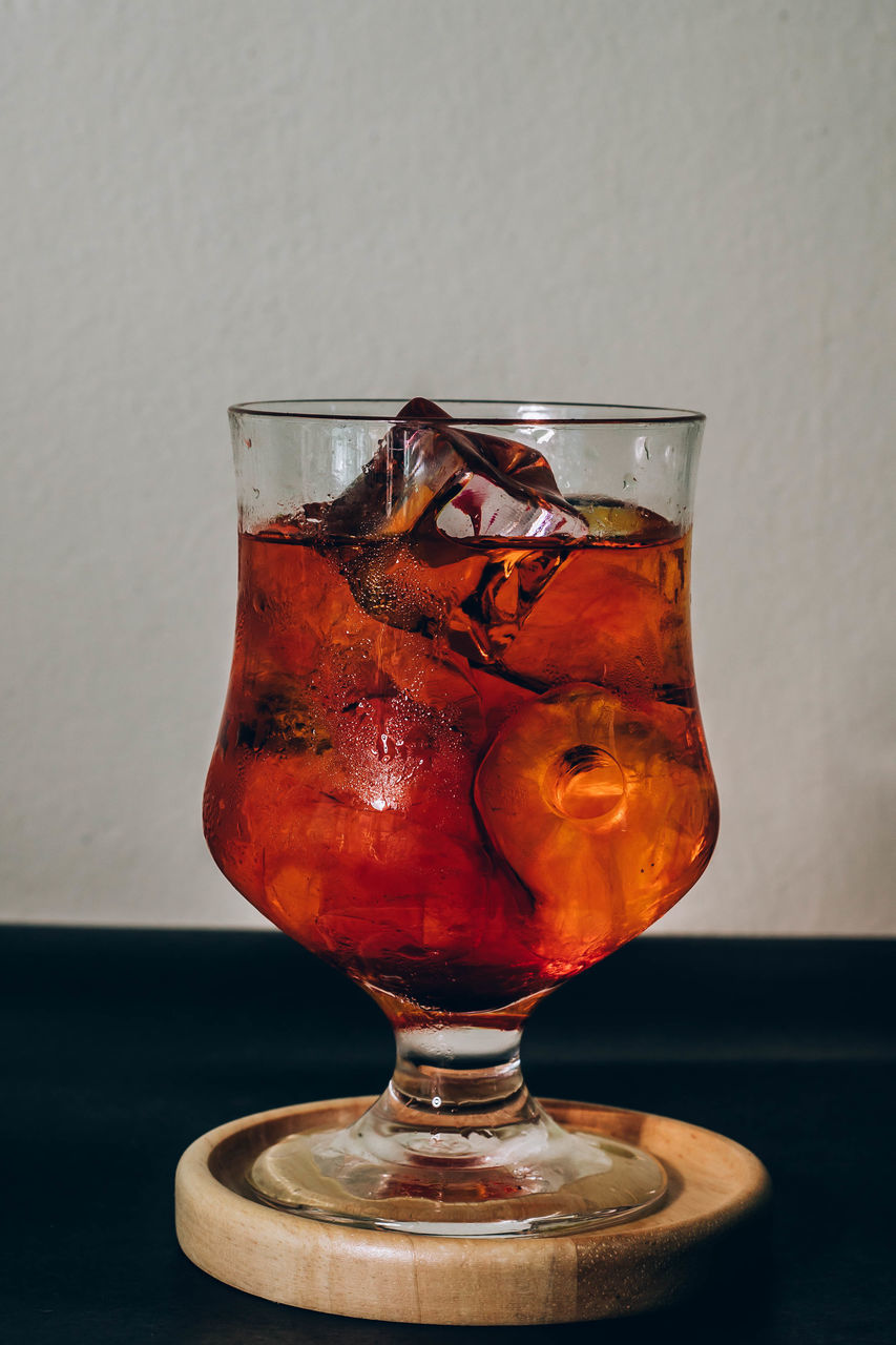 drink, food and drink, refreshment, glass, distilled beverage, household equipment, indoors, alcohol, drinking glass, alcoholic beverage, table, no people, cold temperature, studio shot, frozen, still life, freshness, red, soft drink, whisky
