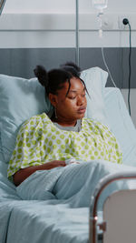 Young woman sleeping on bed at home