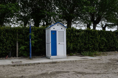 Outhouse against trees at park