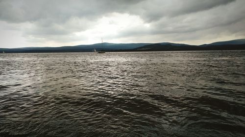 Scenic view of sea against cloudy sky