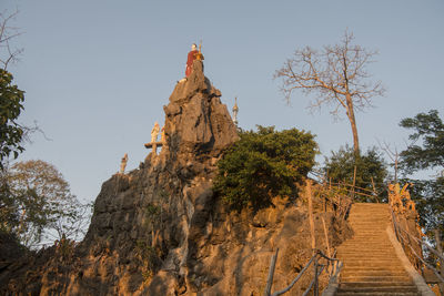 Low angle view of rock formations against sky