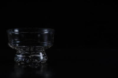 Close-up of glass bowl against black background