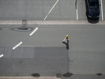 Low section of man walking on road