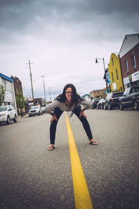 Woman standing on road in city