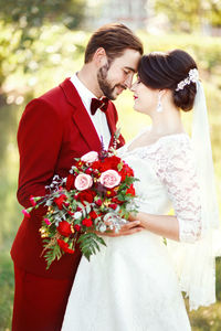 Newly wed couple embracing in marriage ceremony