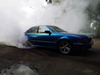 Smoke emitting from car on road