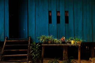 A simple wooden house painted in blue, shows the simplicity and peace of rural life in cambodia